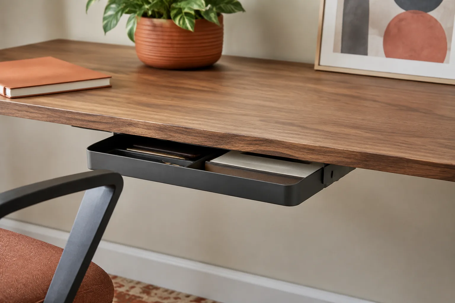Slim drawer mounted underneath a wooden desk for hidden storage